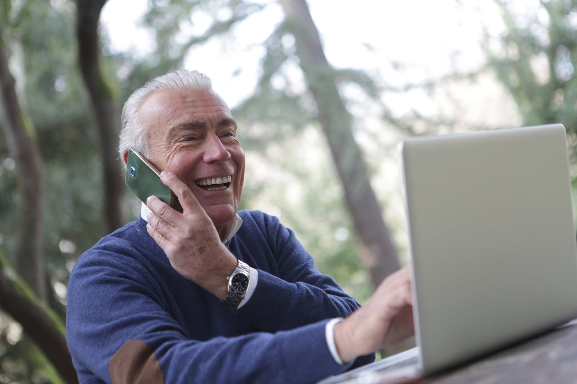 a man in wearing long sleeve shirt using digital gadgets